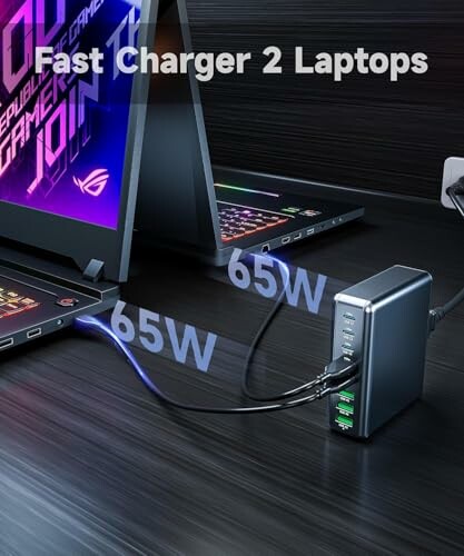 Charger powering two laptops with 65W each.