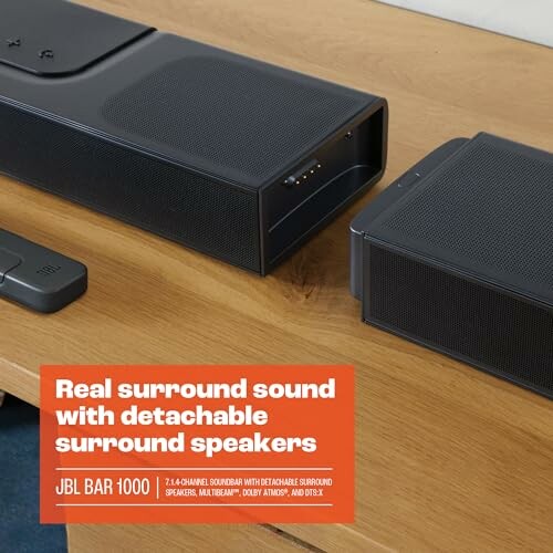 JBL Bar 1000 soundbar with detachable surround speakers on a wooden surface.