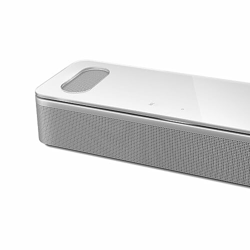 Sleek white speaker with mesh grille and top controls.