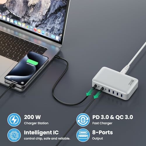 Multi-port charging station connected to laptop and phone.