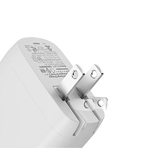 Close-up of a white power adapter plug