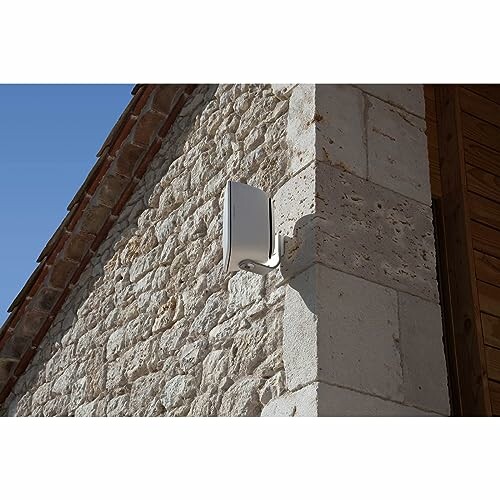 Wall-mounted antenna on stone building exterior