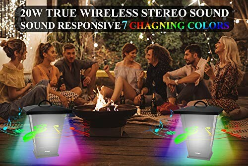 Group of people at a party with wireless speakers and fire pit.